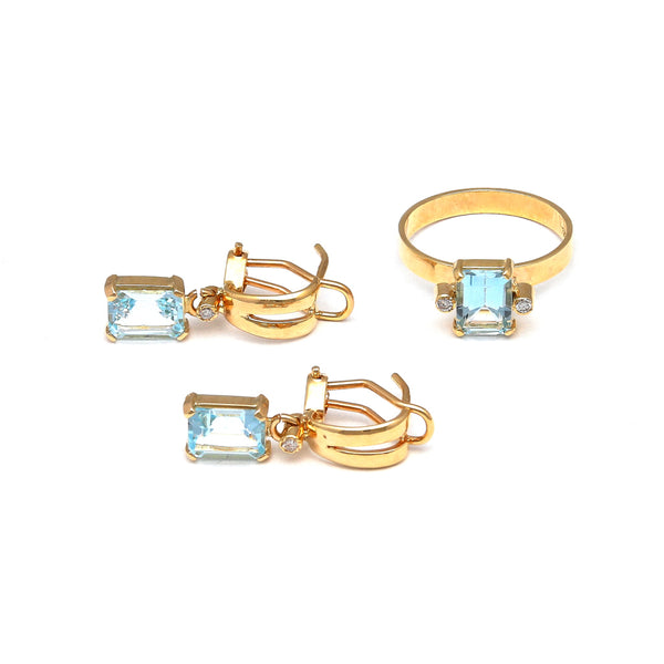 Juego de anillo y aretes estilizados con diamantes y topacios sky blue en oro amarillo 14 kilates.