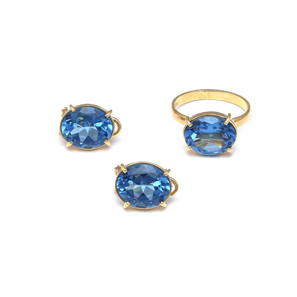 Juego de anillo y aretes estilizados con topacios London blue en oro amarillo 14 kilates.