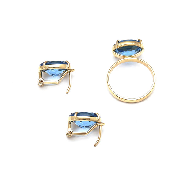 Juego de anillo y aretes estilizados con topacios London blue en oro amarillo 14 kilates.