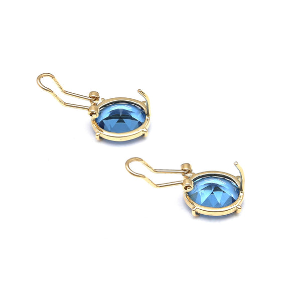 Juego de anillo y aretes estilizados con topacios London blue en oro amarillo 14 kilates.