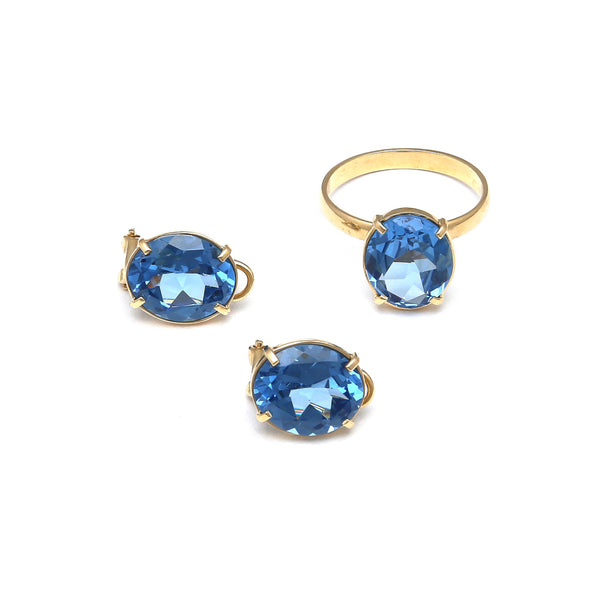 Juego de anillo y aretes diseño especial con topacios London blue en oro amarillo 14 kilates.