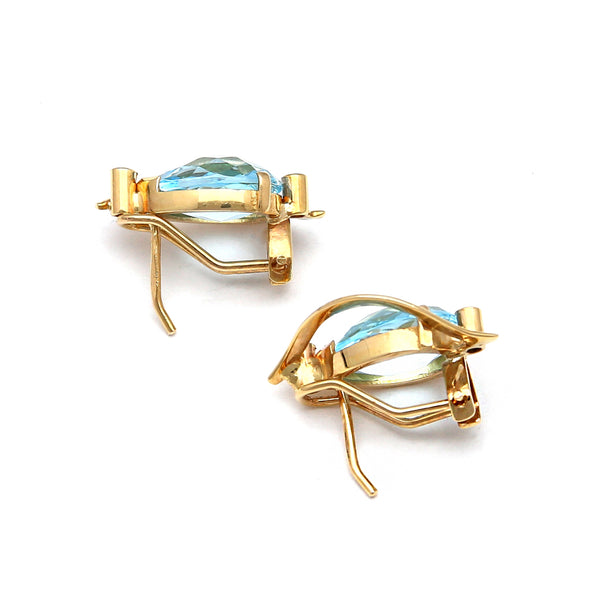 Aretes estilizados con diamantes y topacio azul en oro amarillo 14 kilates.