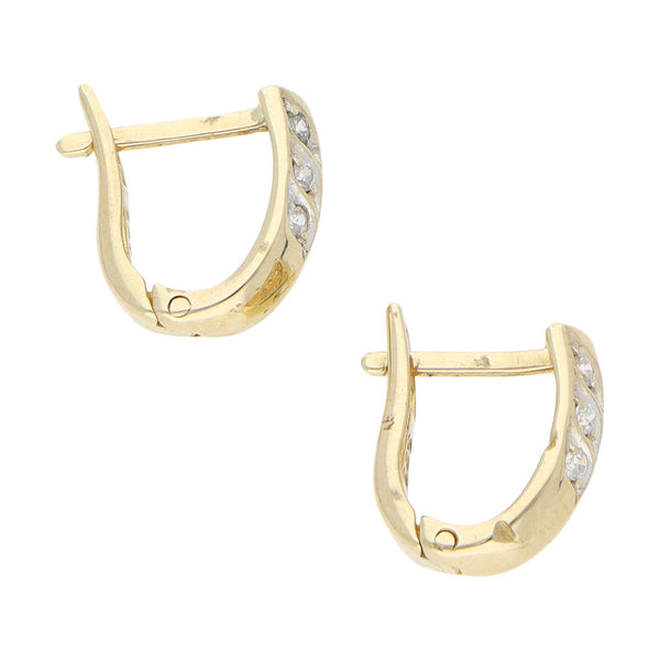 Aretes estilizados con circonias en oro amarillo 14 kilates.