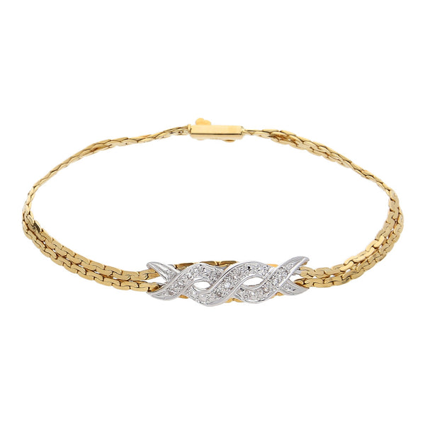 Pulsera eslabón planchado con aplicación y diamantes en oro dos tonos 18 kilates.