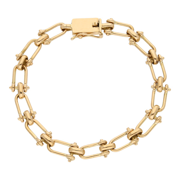 Pulsera eslabón cruzado combinado en oro amarillo 18 kilates.