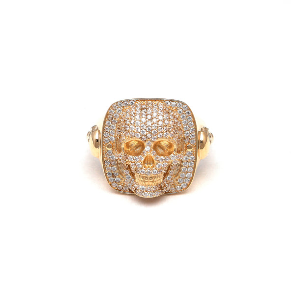 Anillo estilizado motivo calaveras con circonias en oro amarillo 14 kilates.