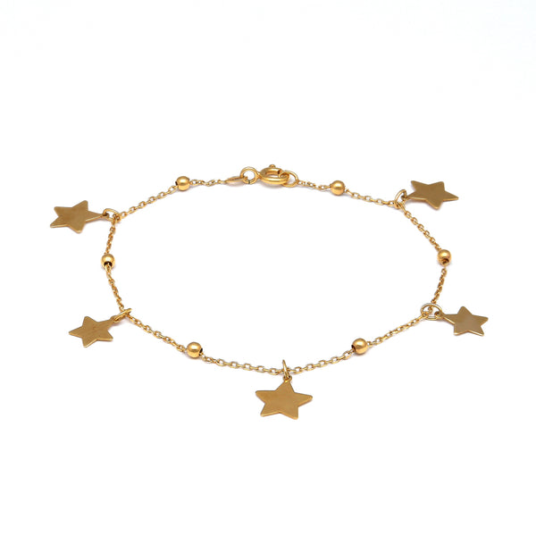 Pulsera eslabón cruzado con esferas y dijes motivo estrella en oro amarillo 14 kilates.