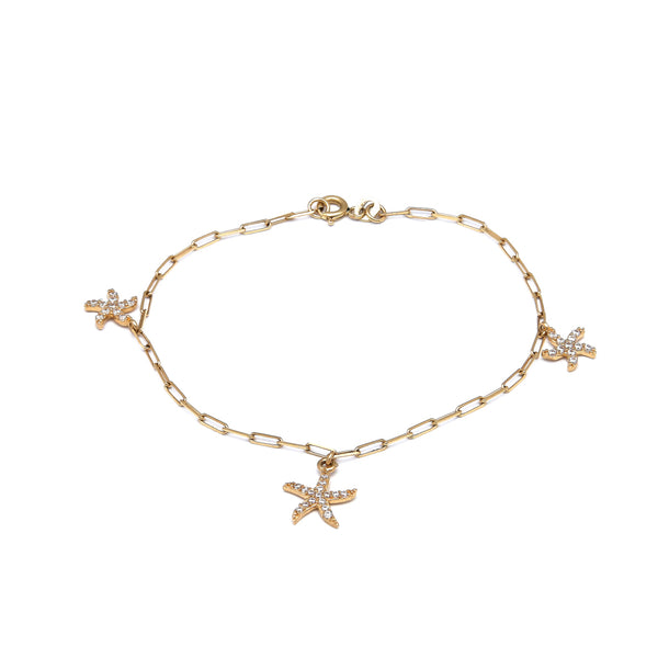 Pulsera eslabón cruzado con colgantes motivo estrella de mar y circonias en oro amarillo 14 kilates.