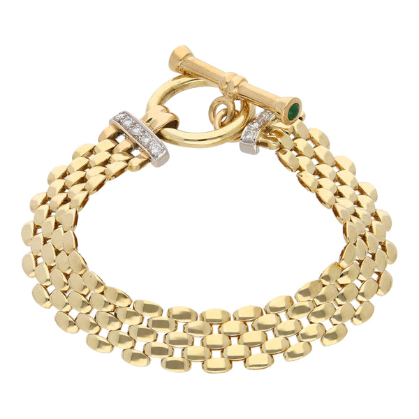 Pulsera eslabón articulado con diamantes y esmeraldas en oro amarillo 14 kilates.