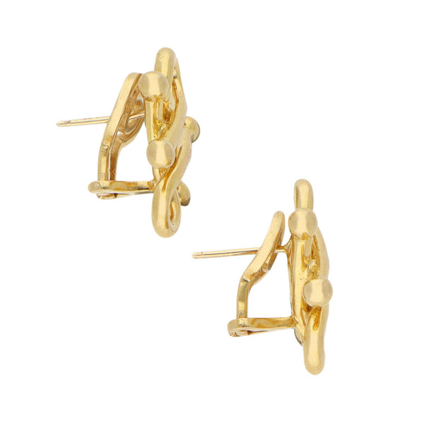 Aretes estilizados firma Tane en oro amarillo 18 kilates.