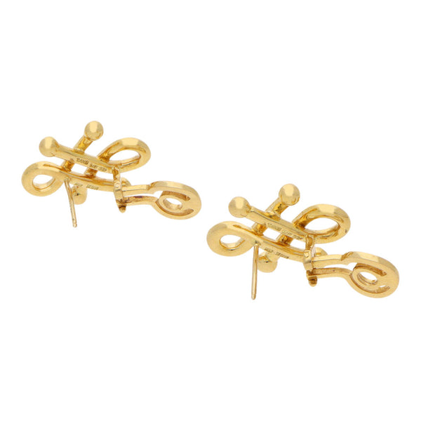 Aretes estilizados firma Tane en oro amarillo 18 kilates.