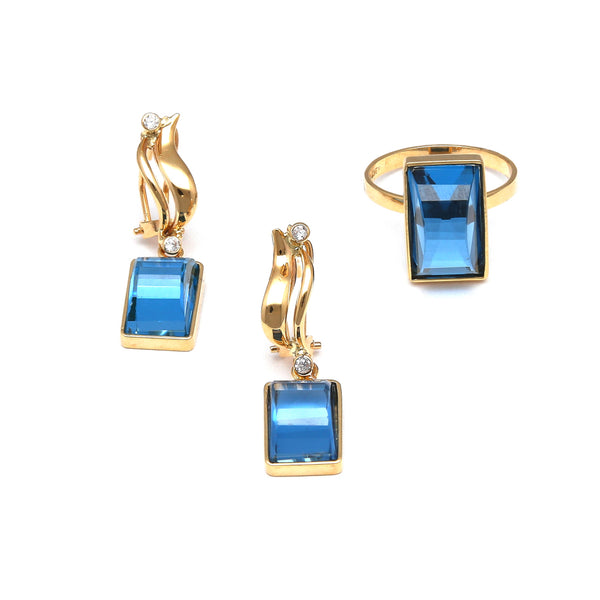 Juego de anillo y aretes estilizados con topacios London blue y circonias en oro amarillo 14 kilates.