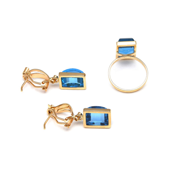 Juego de anillo y aretes estilizados con topacios London blue y circonias en oro amarillo 14 kilates.