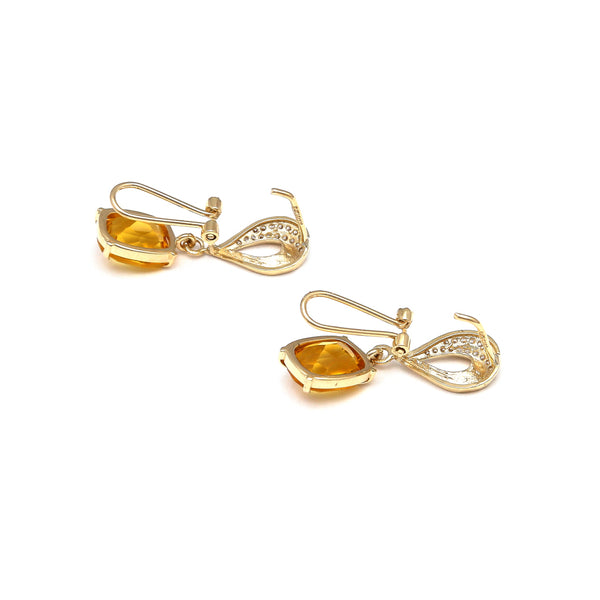 Juego de aretes y dije articulados con citrinos y circonias en oro amarillo 14 kilates.