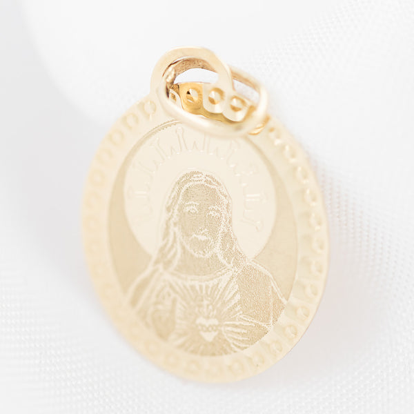 Medalla laminada motivo Sagrado Corazón de Jesús en oro amarillo 14 kilates.