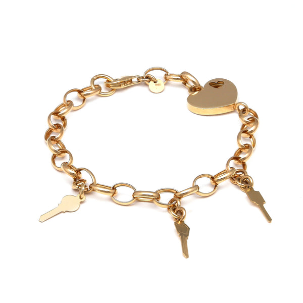 Pulsera eslabón cruzado con aplicación y colgantes motivo corazón y llaves en oro amarillo 14 kilates.