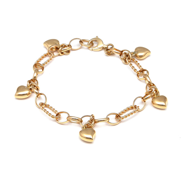 Pulsera eslabón combinado con colgantes motivo corazón en oro amarillo 14 kilates.