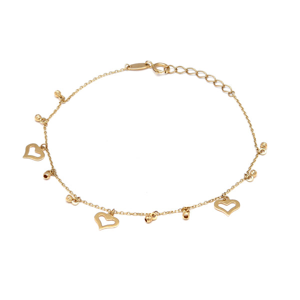 Pulsera eslabón cruzado con colgantes motivo esfera y corazón en oro amarillo 14 kilates.