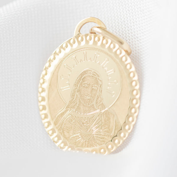 Medalla diseño espcial motivo Sagrado Corazón de Jesús en oro amarillo 14 kilates.