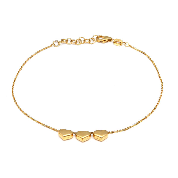 Pulsera eslabón cruzado con aplicaciones motivo corazones en oro amarillo 14 kilates.