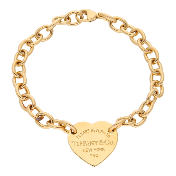 Pulsera eslabón cruzado con aplicación motivo corazón firma Tiffany & Co. en oro amarillo 18 kilates.