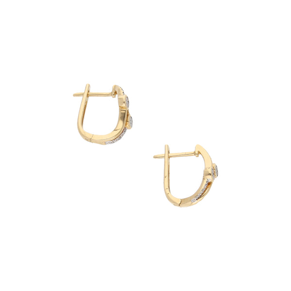 Aretes estilizados con diamante en oro amarillo 14 kilates.